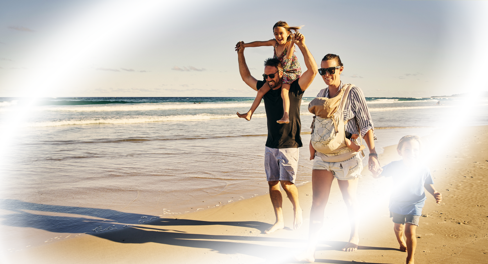 Glaucoma: Image of a happy family walking on the beach with blurred vision streaks sporadically across the scene.